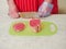 Professional butcher cutting eye of round roast on a green cutting board. Man dressed in white uniform and red and white stripe