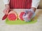 Professional butcher with eye of round roast on a green cutting board. Man dressed in white uniform and red and white stripe apron