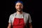 Professional butcher fishmonger in grey t shirt and classic red and white stripe apron