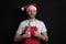 Professional butcher or fishmonger in white t shirt and classic apron and Christmas hat. The model is male in his 40s, slim body