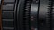 Professional camcorder lens on dark background, macro