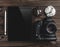 Professional camera, tablet and cookies on a wooden table, relaxing break at home concept