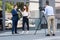 professional cameraman and news reporter interviewing businessman near office