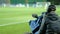 A professional cameraman shoots a football match. Broadcasting a football match