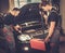 Professional car mechanics inspecting headlight lamp of automobile in auto repair Service.