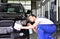Professional car wash - worker in a car dealership polishes the