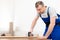 Professional Carpenter Working Using Staple Gun Making Furniture Standing Indoors