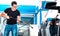 Professional carwash employee washing car at wash station - Working service concept with guy busy on cleaning auto at open air