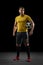 Professional caucasian football soccer player standing isolated on black studio background.