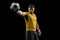 Professional caucasian football soccer player standing isolated on black studio background.