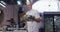 Professional Caucasian male chef in a restaurant kitchen preparing food using a frying pan