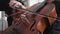 Professional cellist plays in slow motion, close-up strings of a cello