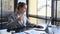 Professional chartered accountant drinking coffee and working with laptop computer at office desk