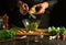 A professional chef adds cheese to a salad using a grater with his hands. Vegetarian products on the kitchen table