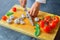 Professional chef cuts vegetables with a sharp knife from Damascus steel.