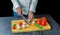 Professional chef cuts vegetables with a sharp knife from Damascus steel.