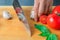 Professional chef cuts vegetables with a sharp knife from Damascus steel.