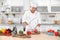 Professional chef cutting pepper on table