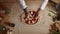 Professional chef prepare pizza dough on table. Man cook adding herbs in kitchen