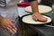 Professional chef prepares a closed meat pie