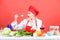 Professional chef on red background. restaurant menu. Dieting. surprised woman cooking healthy food. woman in cook hat