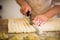 Professional chief making a pastry with dough in a kitchen