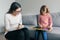 Professional child psychologist talking with child girl in office, child draws a drawing