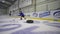 Professional childrens player with hockey stick control the puck with obstacles between the tyres inside ice rink and