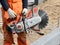 Professional circular saw for work on concrete in hands at the worker