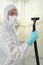 Professional cleaner in protective suit