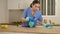 Professional cleaner wipes the table in the kitchen with a rag