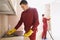 Professional cleaners in rubber gloves cleaning kitchen