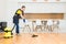 Professional cleaning service. woman in uniform and gloves does the cleaning in a cottage. the worker vacuums the floor