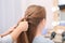 Professional coiffeuse braiding client`s hair