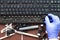 A professional computer electronics technician removes keys from an dirty computer keyboard