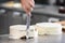 Professional confectioner making a delicious cake in the pastry shop.