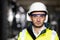 Professional Confident Serious Engineer Looking at Camera, Wearing Safety Uniform and Goggles Standing at Heavy Industry