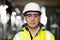 Professional Confident Serious Engineer Looking at Camera, Wearing Safety Uniform and Goggles Standing at Heavy Industry