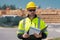 Professional construction worker in new house. Portrait of worker man outdoor. Construction worker with hardhat helmet