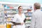 Professional conversing with customer. Portrait of medical professional conversing with customer at drugstore.