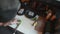 Professional cook cutting avocado into thin slices to use as decoration for a sushi dish. Overhead top down view of