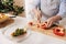 Professional cook cutting pepper for dinner in the kitchen