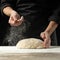A professional cook in a professional kitchen prepares flour dough to make bio-italian pasta. concept of nature, italy, food, diet