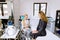 Professional cosmetologist. Female doctor talking to her client young woman while working in the beauty clinic, making