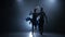 Professional couple of jive dancers posing in smoky studio, silhouette