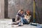 Professional couple sitting together on floor and discussing renovation home