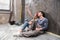 Professional couple sitting together on floor and discussing renovation home