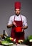 Professional cuisine concept. Chef in burgundy uniform prepares meal.