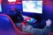 Professional cyber gamer studio room with personal computer armchair, keyboard for stream in neon color blur background