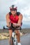 Professional cyclist biking on road bike training for triathlon competition on road bicycle in Hawaii. Triathlete